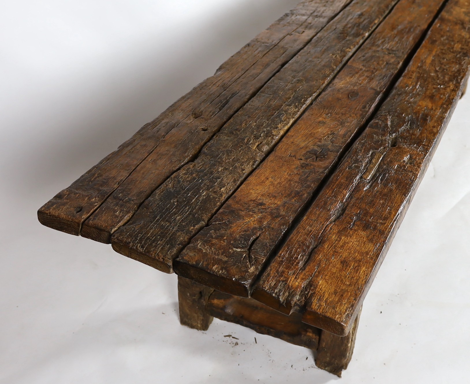 A rustic oak four plank top refectory table, length 320cm, width 78cm, height 78.5cm